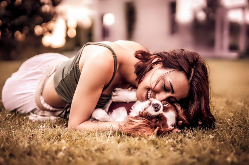 Woman in Tank Top Playing with her Dog